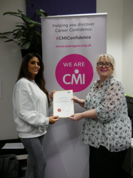 CMI student Nisha presented with certificate by tutor Bridgette Bennett