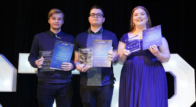 Three apprentices receive their awards on stage