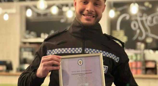 Police officer and former student holding certificate